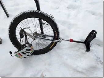 Unicycle lying in the snow, 'cause why not? It's the only snow tire we had